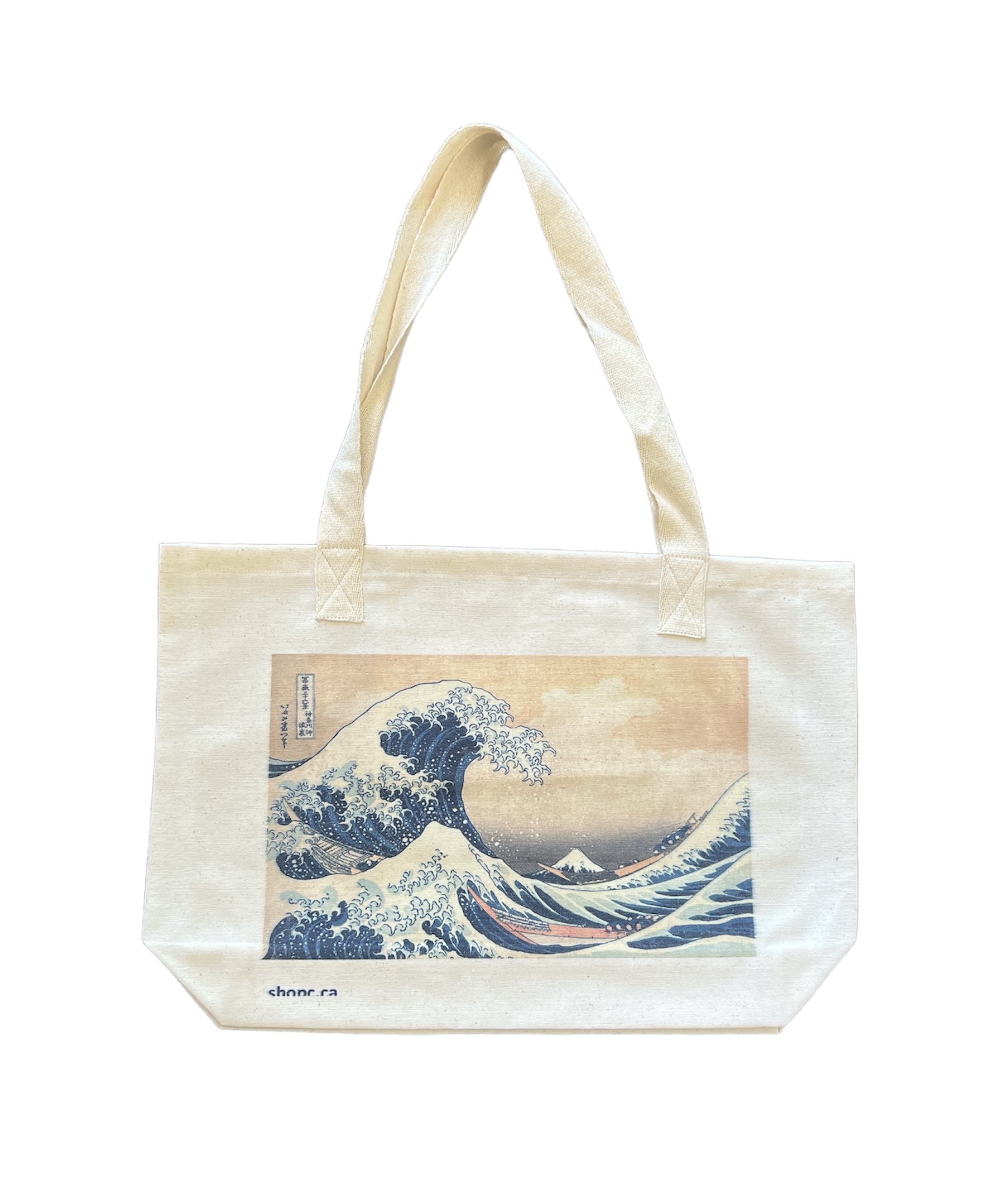 Tote bag featuring Hokusai’s The Great Wave off Kanagawa, with a towering blue wave curling over boats and Mount Fuji in the distance.